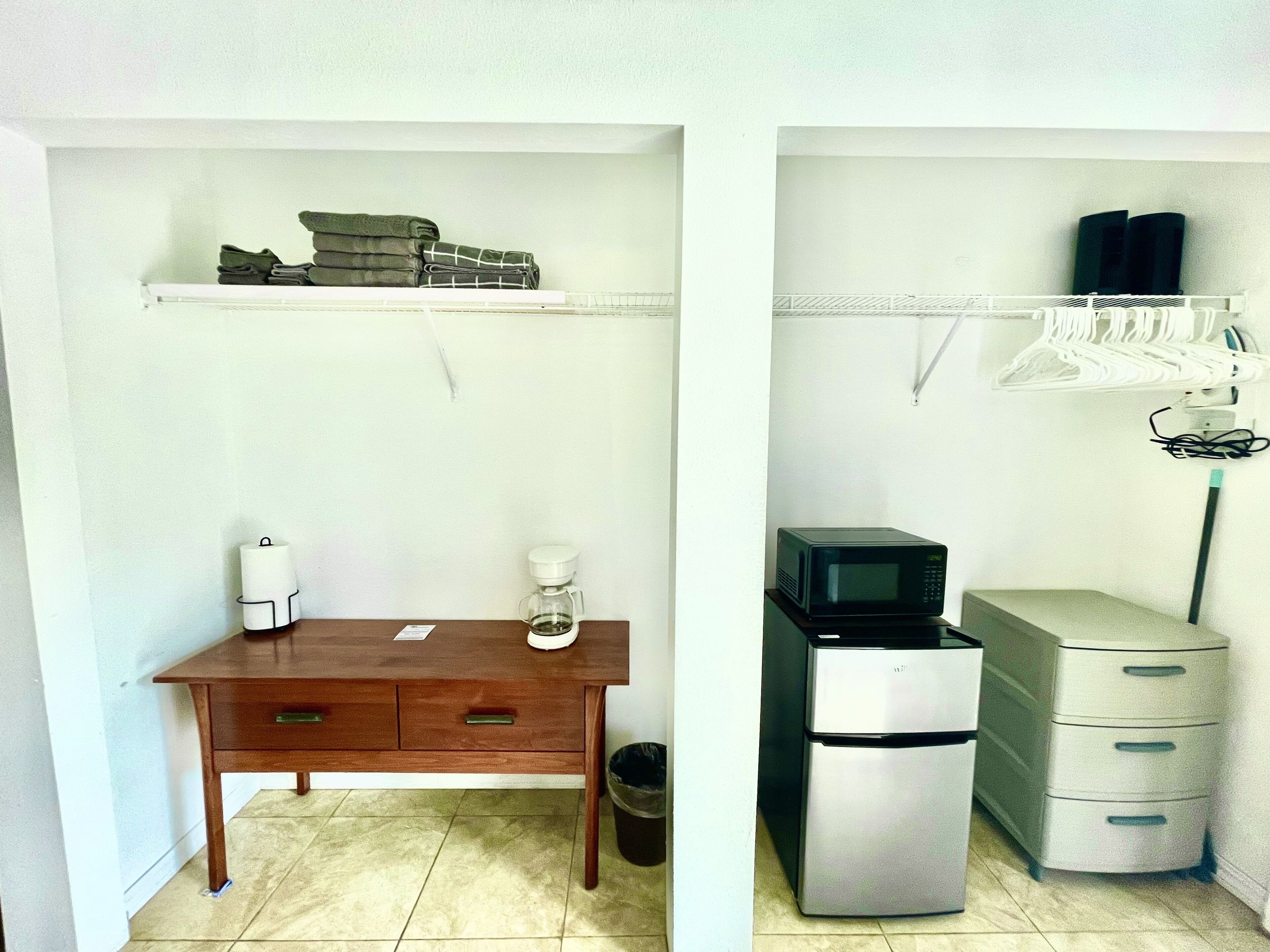 A compact kitchenette with a coffee maker, a microwave, and a refrigerator.