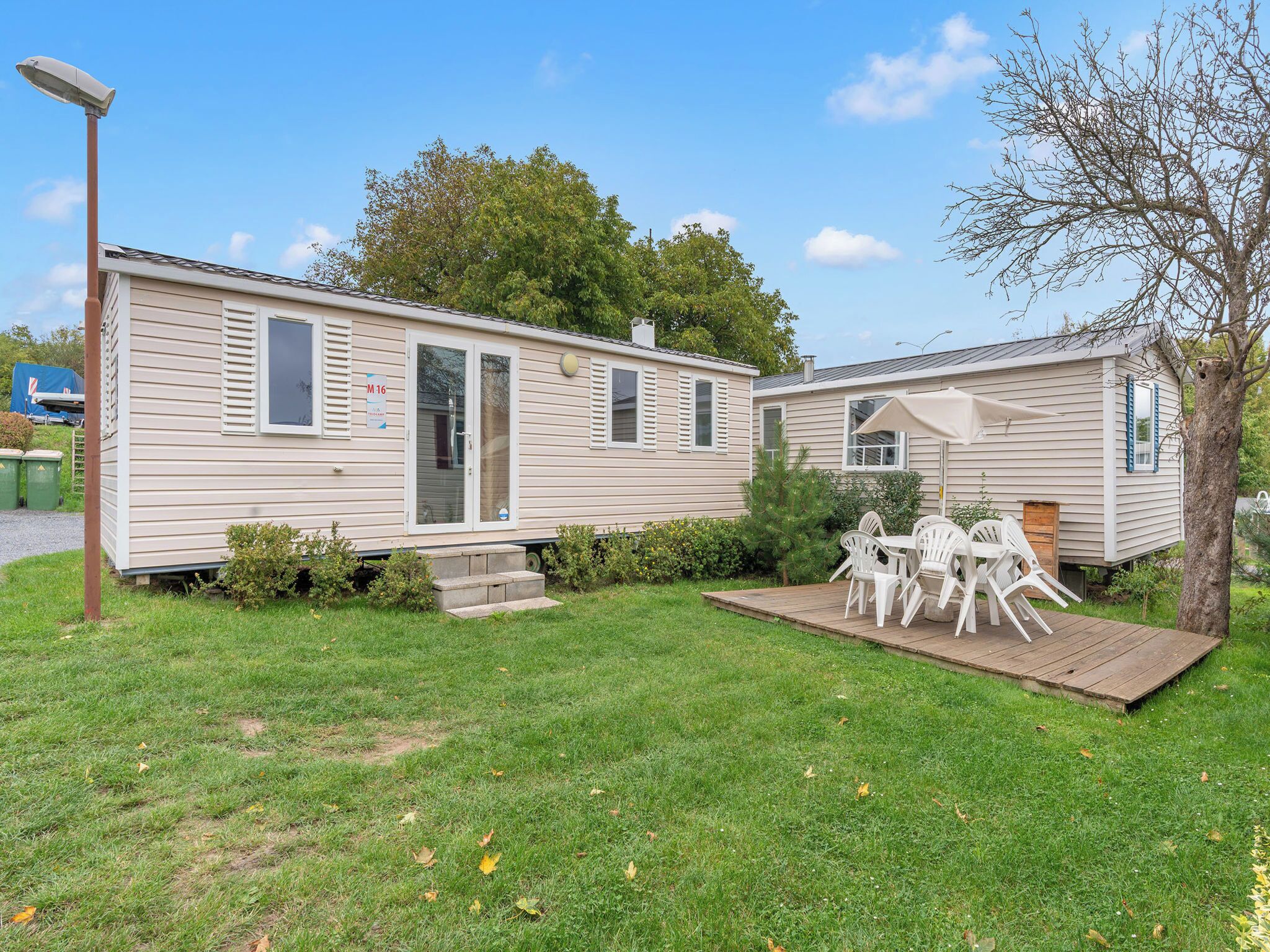 A mobile home with a patio area and outdoor seating.