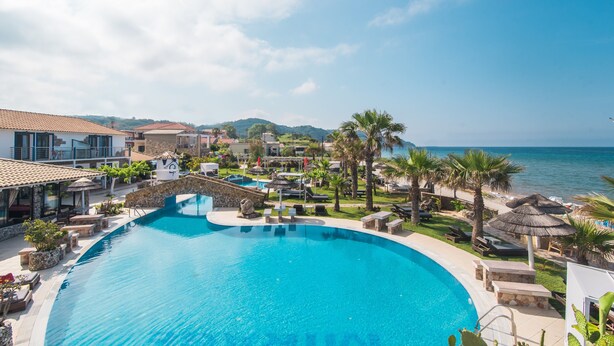 A resort with a large swimming pool, lounge areas, and a view of the sea. - 'Mirage Arillas Studio Type C18' with Shared Pool & Wi-Fi (corfu)