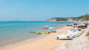 A beach with boats and a rocky shoreline. - 'Mirage Arillas Studio Type C18' with Shared Pool & Wi-Fi (corfu)