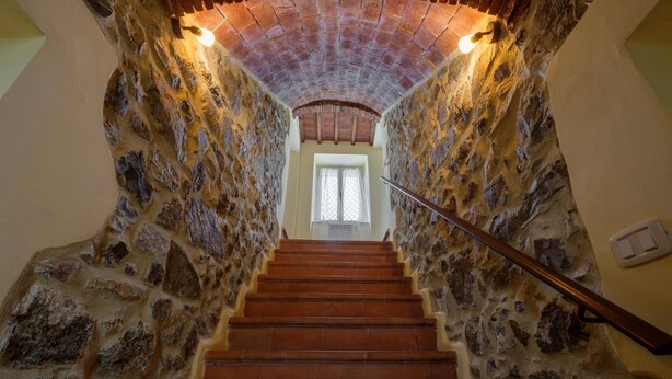 A stone staircase leading to a room with a wooden ceiling and a window. - Pet-Friendly Holiday Home Fonte Etrusca with Pool, Garden & Wi-Fi (sorano)