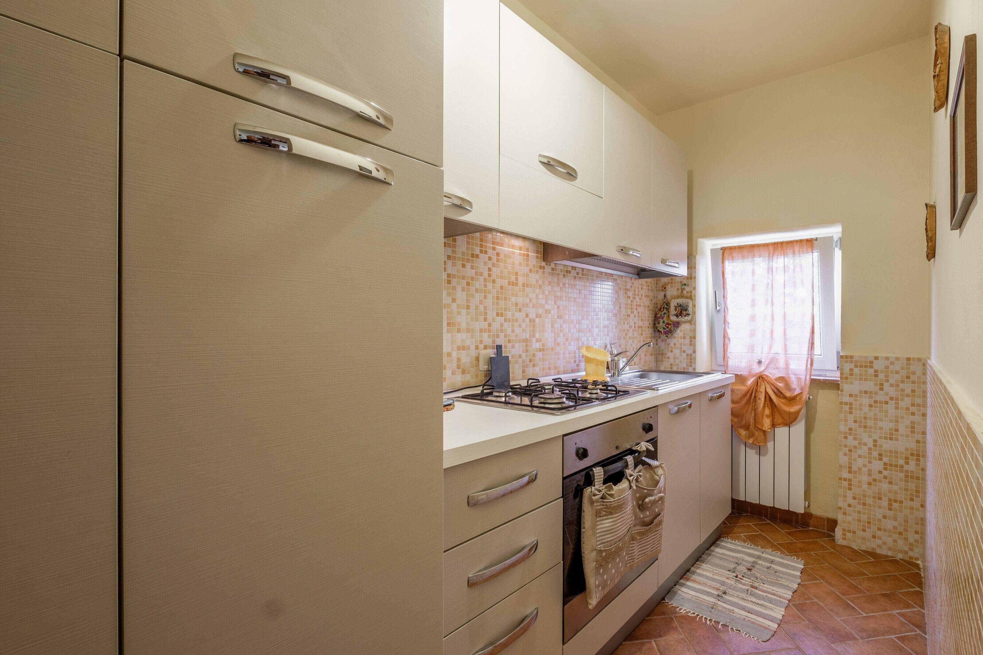 A kitchen with a stove, oven, and cabinets.