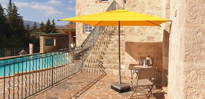 A stone building with a pool, outdoor seating, and a staircase. - REAL EXPERIENCE IN PROVENCE... (Tourrettes)