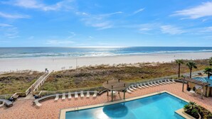 Ein Poolbereich mit Blick auf Strand und Meer.