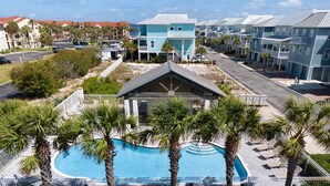 A resort with a pool surrounded by palm trees, a covered pavilion, and beachfront views. - Tequila Sunrise 4 Bedroom Home by RedAwning (Navarre)