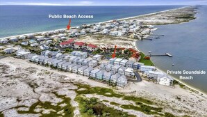 An aerial view of a coastal residential area with a public beach access, a private beachfront, and a marked location for 'Equilla Sunrise'. - Tequila Sunrise 4 Bedroom Home by RedAwning (Navarre)