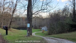 A mailbox with a sign indicating a welcome to a lake house on Green Up.