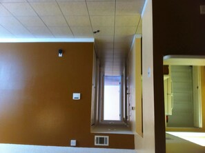 Stylish corridor leading to a bright, welcoming area.