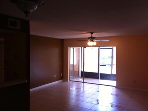 Enjoy the airy feel of this room with a high ceiling and sliding glass door leading to an outdoor area.