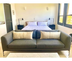 King bed with bright windows