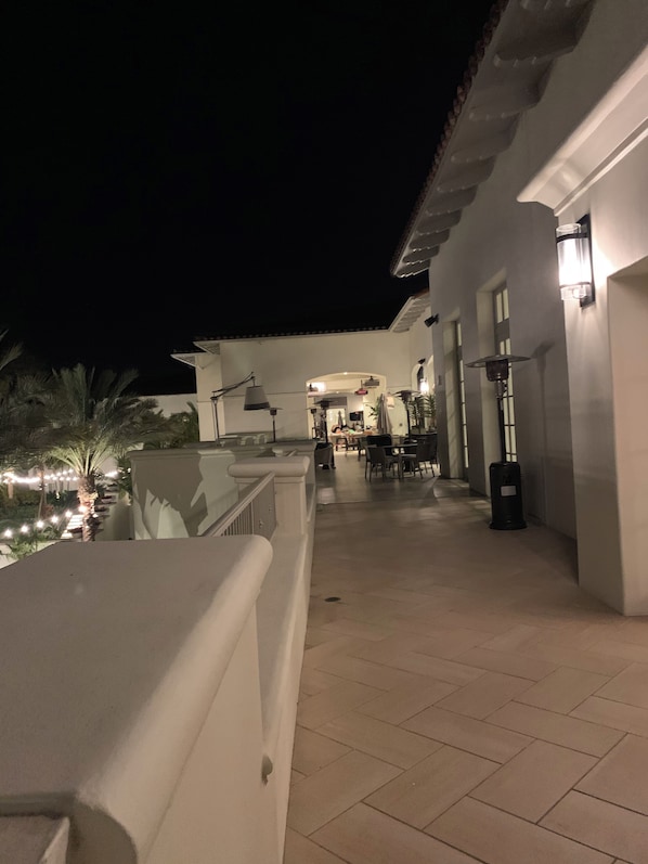 A nighttime outdoor area with a paved walkway, outdoor seating, and ambient lighting. - Four Seasons Residence Club Aviara - 3792/week of 10/9-16 (Carlsbad)