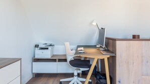 A modern office space with a desk, chair, printer, and lamp. - LOFT ON THE BANKS OF THE LOIRE (Montlouis-sur-Loire)