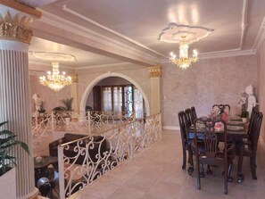 Stunning dining area with a grand staircase and elegant moldings, perfect for hosting gatherings.