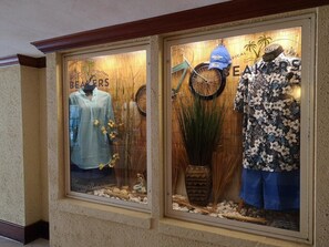 A storefront with mannequins displaying clothing.