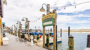 A waterfront marina with wooden docks and moored boats. - Club Wyndham Emerald Grande - 1 Bedroom (Destin)