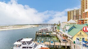 A marina with boats docked, a pier extending into the water, and a building labeled "Nautical Treasures". - Club Wyndham Emerald Grande - 1 Bedroom (Destin)