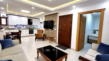 Economy Apartment, 3 Bedrooms, Kitchen | Living room | 55-inch Smart TV with satellite channels, TV, Netflix