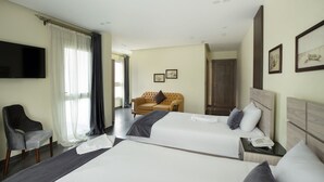 A hotel room with two beds, a sofa, a TV, and a telephone. - Brothers Pyramids View (Giza)