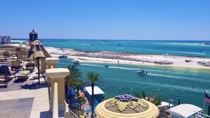 A resort with a view of a turquoise sea, a sandy beach, and a clear sky. - Bright Corner Unit with Stunning Gulf Views & Sunsets (Destin)