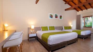 A hotel room with a bed, bedside tables, a desk, and chairs.