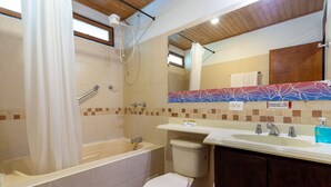 Een badkamer met een bad, toilet en wastafel.