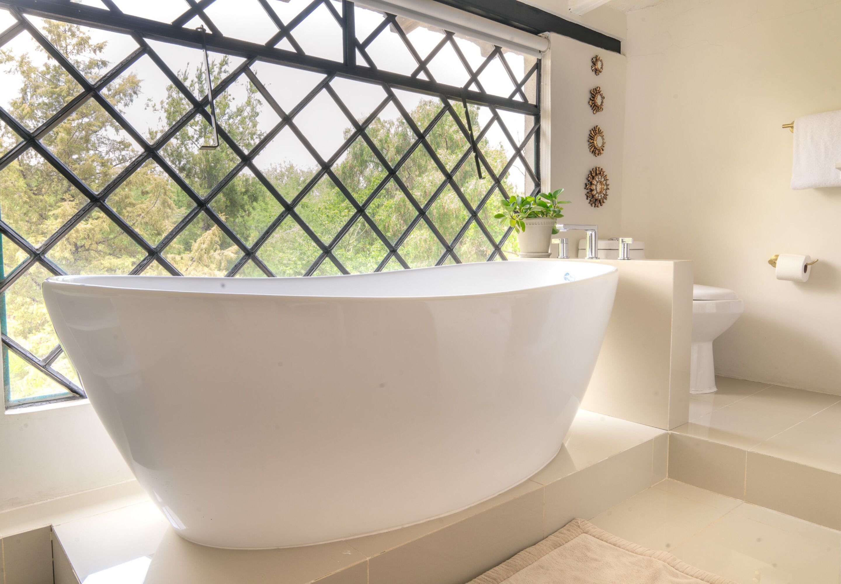 A modern bathroom with a freestanding bathtub, a sink, and a toilet.