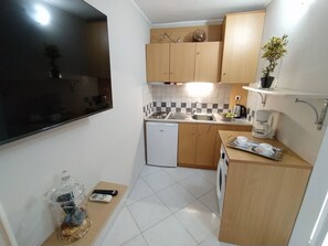 A compact kitchen with a dishwasher, a sink, a coffee maker, and a small countertop. - Modern Quiet Apartment in Rhodes center (Rhodes)
