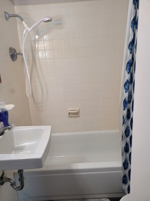 Combined shower/bathtub, towels, toilet paper