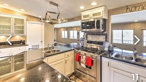 A modern kitchen with granite countertops, stainless steel appliances, and a large island. - New!!! Amazing river and mountain deck view home!!!! (Parker)