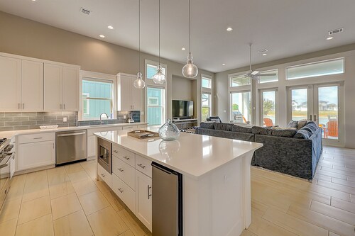 Modern, waterfront home with private pool, dock, balconies, central AC, and WiFi