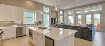 Modern, waterfront home with private pool, dock, balconies, central AC, and WiFi