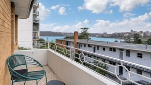 A balcony with a view of a cityscape and water body. - Bright & Peaceful Top-Floor Retreat with Harbour Views (Manly)