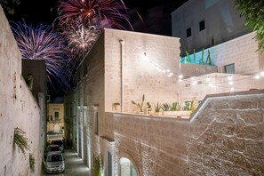Stroll through a charming, historic alleyway lined with arched doorways and exposed brickwork.