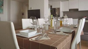 A dining area with a table set for four, including wine glasses, plates, and cutlery. - MALAGA BEACHFRONT PARADISE (Malaga)