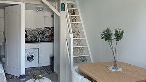 A compact living space with a kitchen, a dining area, and a staircase. - Comfortable Cottage 4 Pers, Beach 200m, Private Parking (La Faute-sur-Mer)