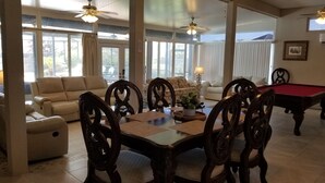 A spacious living room with a dining table, sofas, and a pool table. - Exclusive 2850 sf Pool Home near Perdido Beaches & NAS, Heated Pool, 2 Masters! (Pensacola)