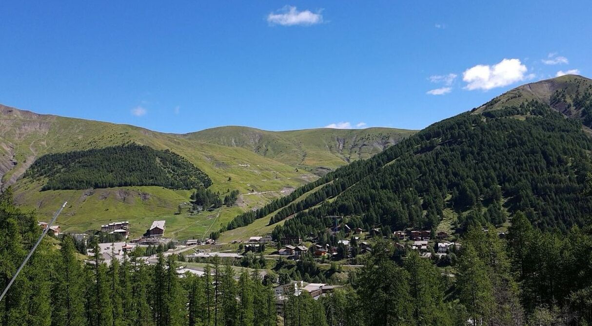A mountainous landscape with a small village nestled among the hills.
