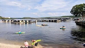 A calm waterfront with docked boats and a pier extending into the water.