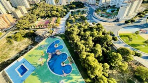 A residential area with high-rise buildings, a roundabout, and a swimming pool complex.