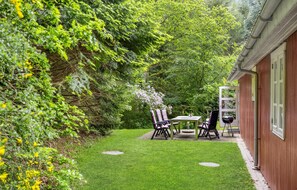 Enjoy al fresco dining on the patio with a barbecue grill and seating for two.
