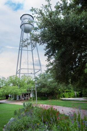 A water tower labeled "GRUEN" amidst a garden with various plants and flowers. - Old Mills Resort OM A6 3 Bedroom Condo by RedAwning (New Braunfels)