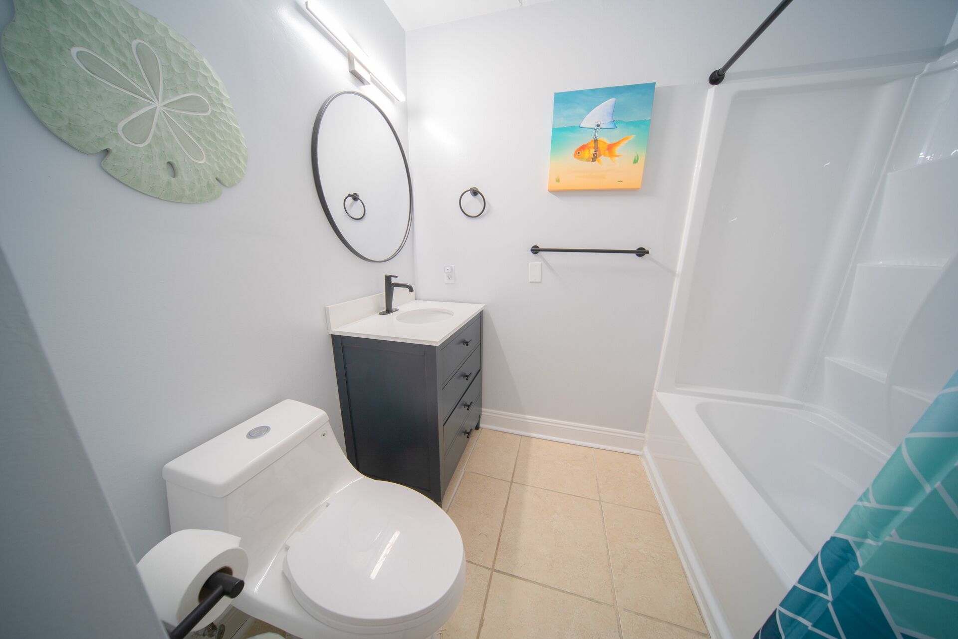 A bathroom with a toilet, sink, and bathtub.