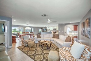 A spacious living area with a sofa set, a coffee table, and a patterned rug. - Walking Distance to the Beach! Canal / Pool Home! (Marco Island)