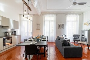 Une cuisine moderne avec un coin repas, un canapé et un meuble de rangement.