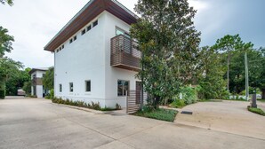 A modern two-story building with a white facade and a sloped roof. - Light, Bright and Full of Delight! 2 Blocks to Park Ave (Winter Park)