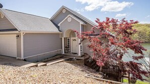 A house with a garage, a covered porch, and a small deck. - Lakefront Family Retreat | Sleeps 10+ | Pet-Friendly | Swim & Fish Off the Dock (Sunrise Beach)