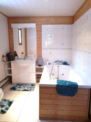 Douche, baignoire à remous, séchoir à cheveux, serviettes fournies