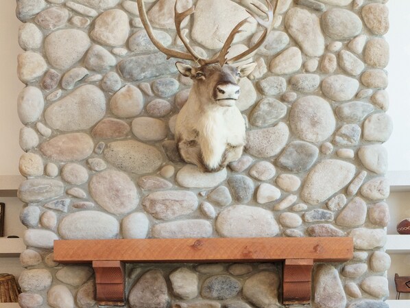A stone wall with a mounted animal head.