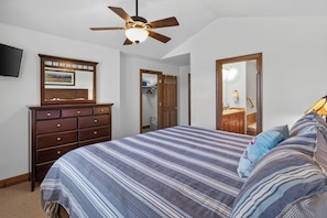 A bedroom with a bed, dresser, ceiling fan, and a television on the wall. - Beautiful Home with Private Hot Tub Deck Fireplace (Breckenridge)