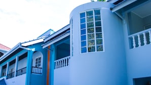 A row of blue buildings with balconies and large windows. - Ocean View Beach Hotel (Ocho Rios)